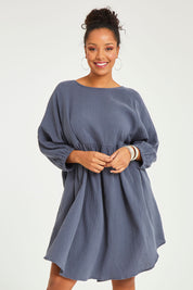 Model Noli wearing size 14 of the Feeling Free Cotton Smock Dress in colour Smoke (Grey), from the front, cropped image