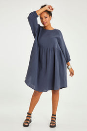 Model Noli wearing size 14 of the Feeling Free Cotton Smock Dress in colour Smoke (Grey), from the front, showing the whole outfit