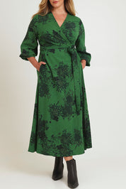 Model Chanel wearing size 16 of the Wrap Me Up In Cotton Maxi Dress in colour Emerald (Green), from the front, cropped image