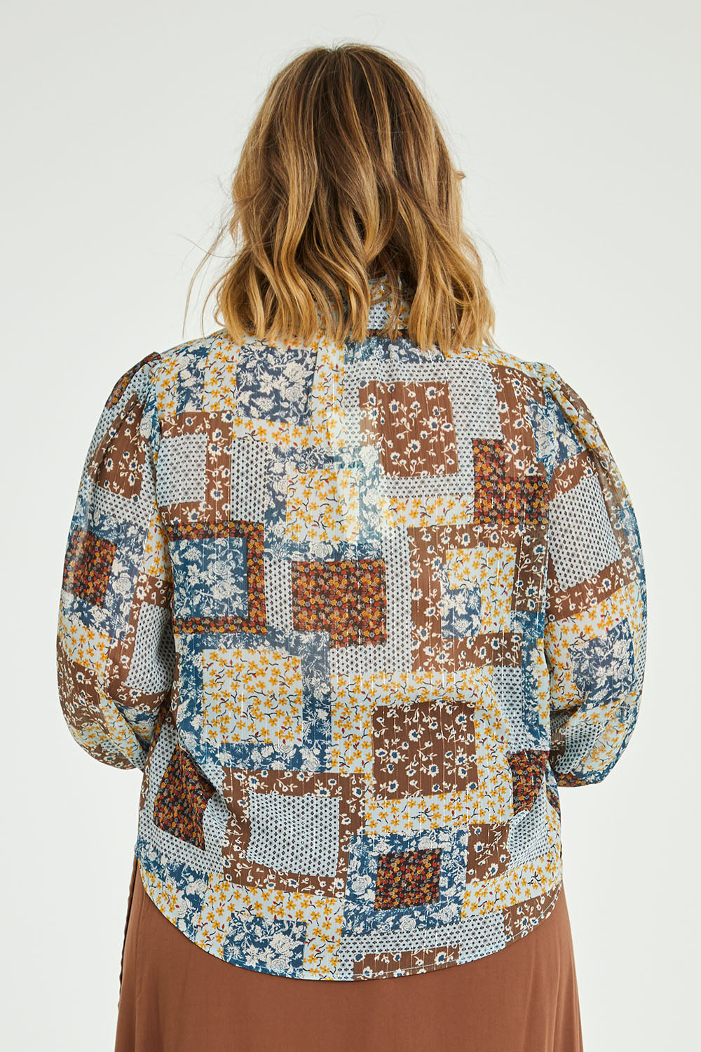 Model Jess wearing size 14 of the Not A Patch On You Blouse in colour Tealpatch (Blue), from the back