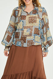 Model Jess wearing size 14 of the Not A Patch On You Blouse in colour Tealpatch (Blue), from the front, cropped image