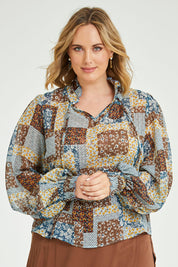Model Jess wearing size 14 of the Not A Patch On You Blouse in colour Tealpatch (Blue), from the front, cropped image