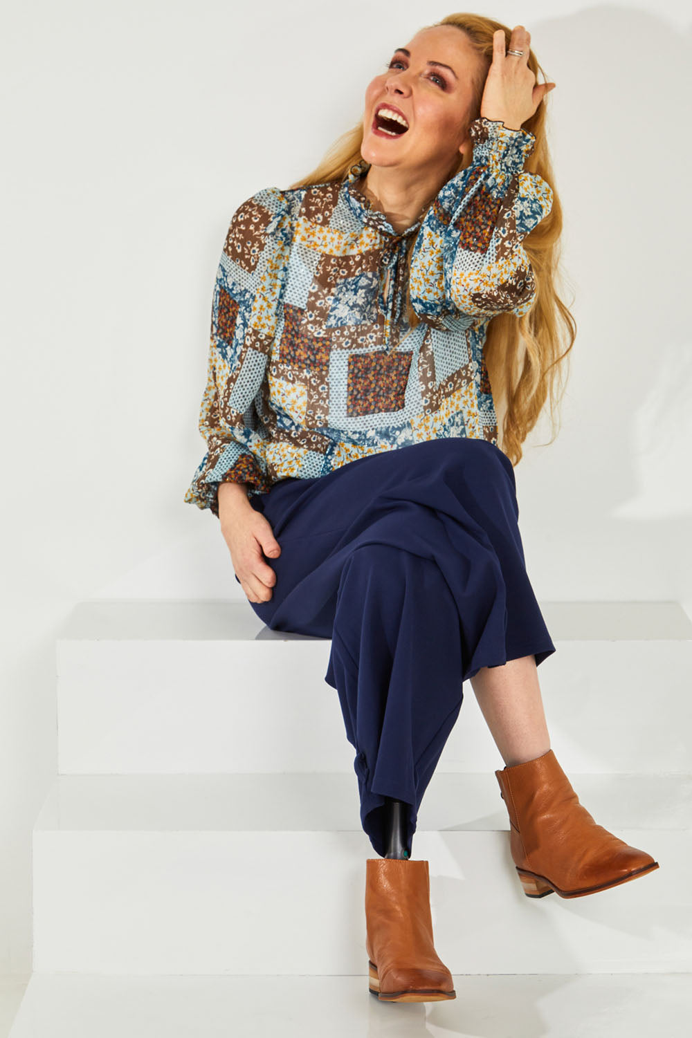 Model Lisa wearing size 10 of the Not A Patch On You Blouse in colour Tealpatch (Blue), from the front, showing the whole outfit