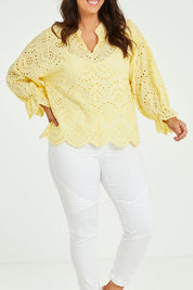 Model Laura wearing size 14 of the Sweet Pea Broderie Blouse in colour Sun, from the front, cropped image