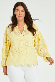Model Laura wearing size 14 of the Sweet Pea Broderie Blouse in colour Sun, from the front, cropped image