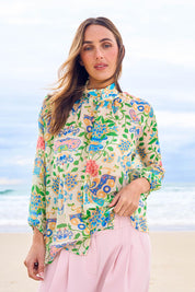 Model Tegan wearing size 10 of the High Tea Garden Party Blouse in colour Garden, from the front, showing the whole outfit