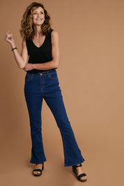 Model Emma wearing size 10 of the Shaking My Tail Feather Flared Jeans in colour Indigo (Blue), from the front, showing the whole outfit