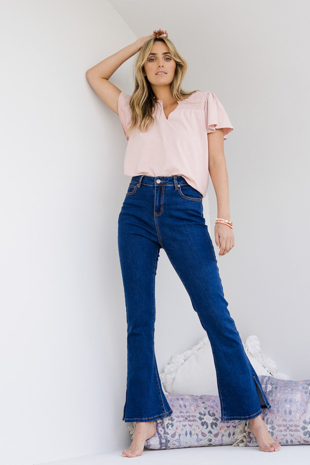 Model Tegan wearing size 10 of the Shaking My Tail Feather Flared Jeans in colour Indigo (Blue), from the front, showing the whole outfit