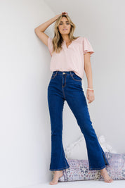 Model Tegan wearing size 10 of the Shaking My Tail Feather Flared Jeans in colour Indigo (Blue), from the front, showing the whole outfit