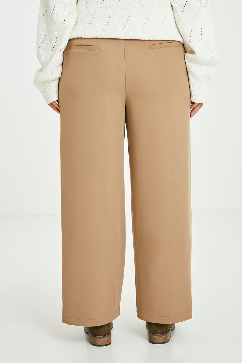 Model Laura wearing size 14 of the All For Love Pants in colour Camel, from the back