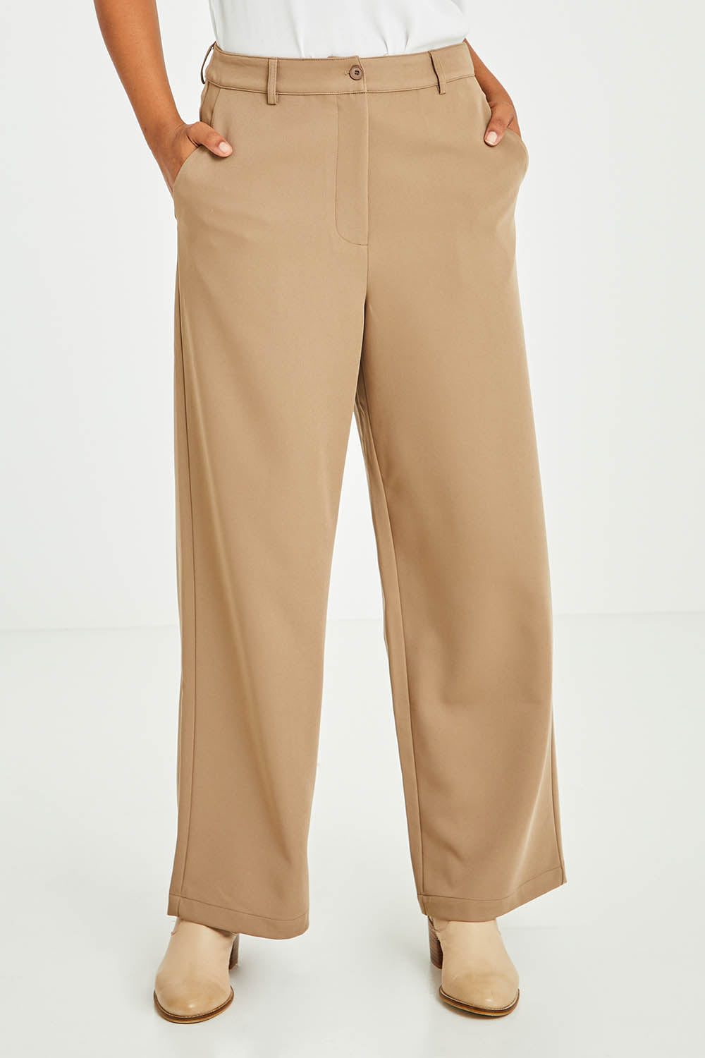 Model Olivia wearing size 10 of the All For Love Pants in colour Camel, from the front, cropped image