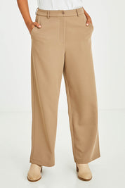 Model Olivia wearing size 10 of the All For Love Pants in colour Camel, from the front, cropped image