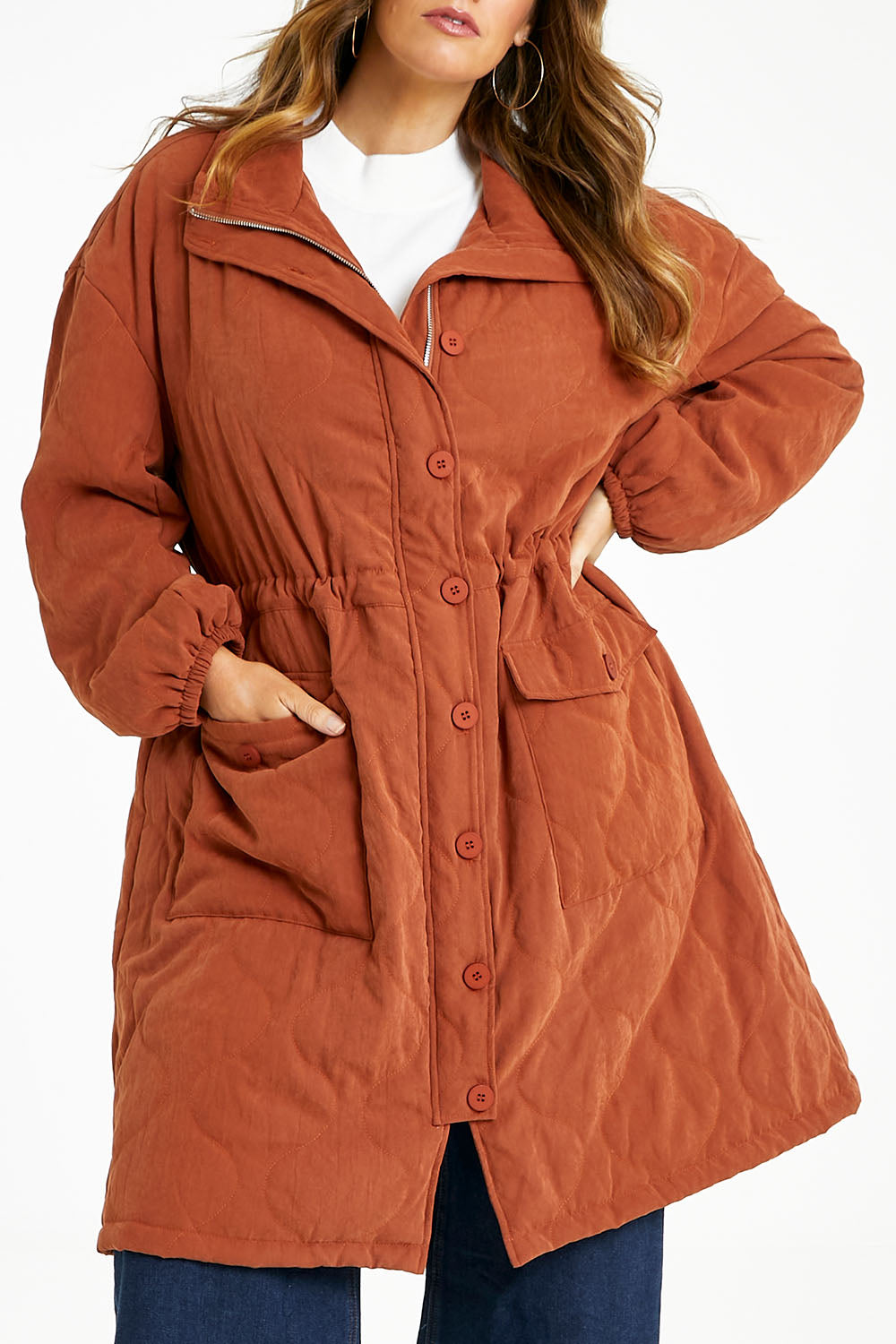 Model Laura wearing size 14 of the Heart Warming Quilted Anorak in colour Rust, from the front, cropped image