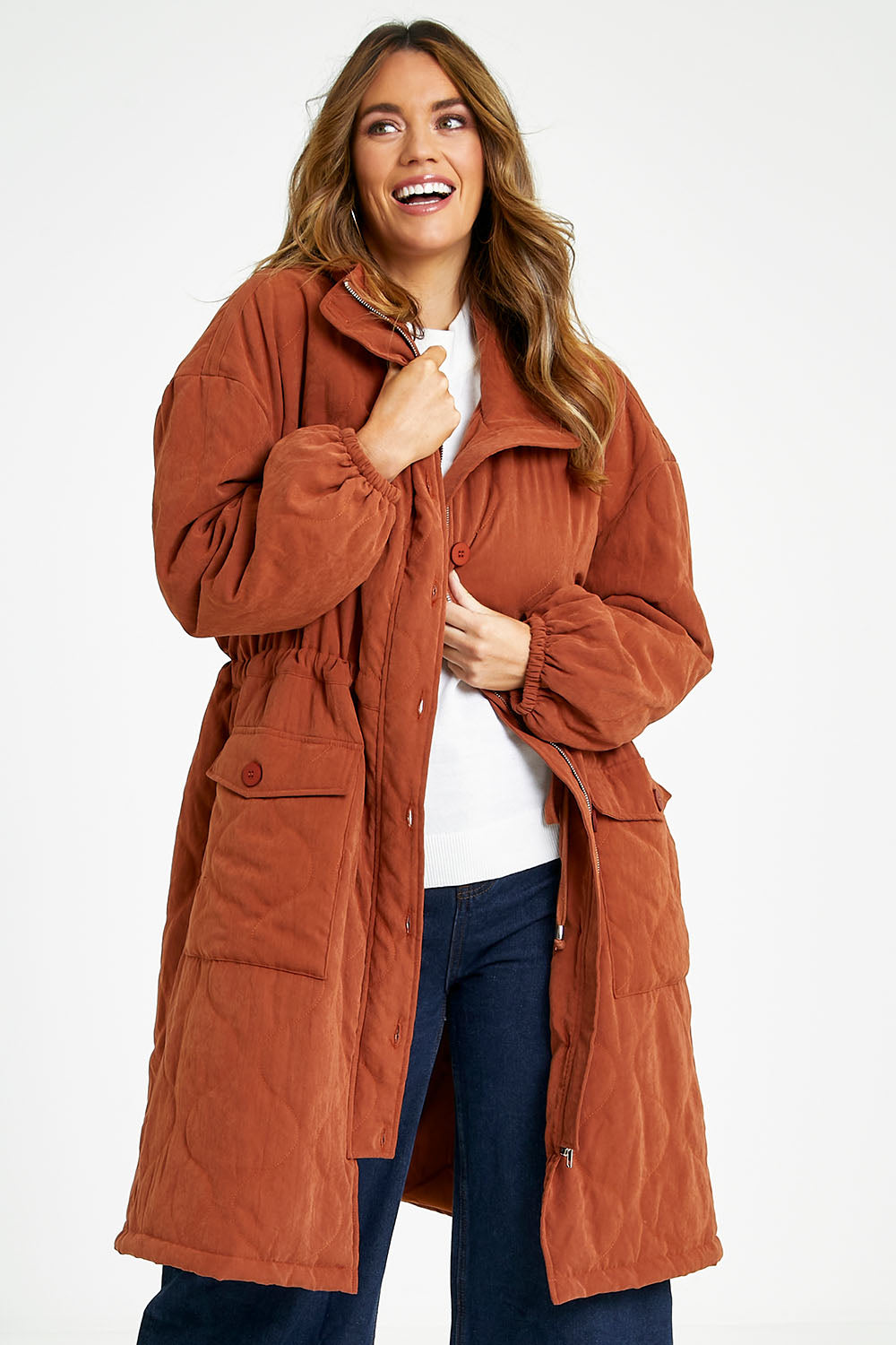 Model Laura wearing size 14 of the Heart Warming Quilted Anorak in colour Rust, from the front, cropped image