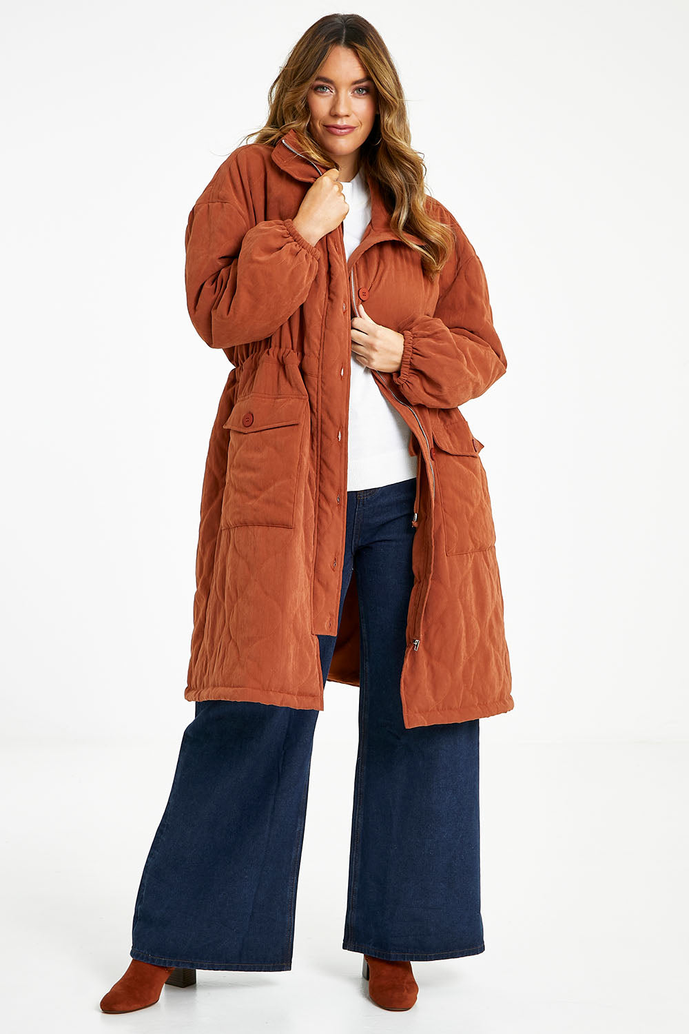 Model Laura wearing size 14 of the Heart Warming Quilted Anorak in colour Rust, from the front, showing the whole outfit