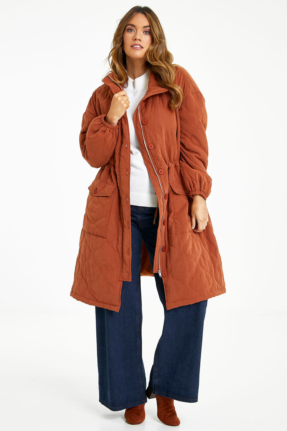 Model Laura wearing size 14 of the Heart Warming Quilted Anorak in colour Rust, from the front, showing the whole outfit