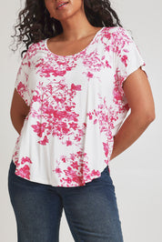 Model Terri-Leigh wearing size 14 of the Falling Flowers Tee in colour Pinkwhite (Pink), from the front, cropped image