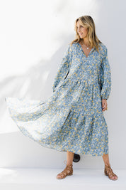 Model Tegan wearing size 10 of the Light Of The Sun Cotton Dress in colour Bluefleur (Blue), from the front, showing the whole outfit