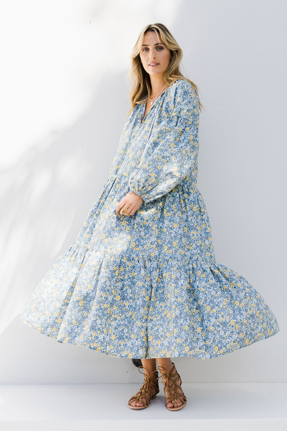 Model Tegan wearing size 10 of the Light Of The Sun Cotton Dress in colour Bluefleur (Blue), from the front, showing the whole outfit
