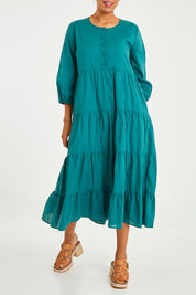 Model Noli wearing size 14 of the Tiers Of Joy Cotton Maxi Dress in colour Pine (Green), from the front, cropped image