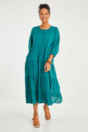 Model Noli wearing size 14 of the Tiers Of Joy Cotton Maxi Dress in colour Pine (Green), from the front, showing the whole outfit