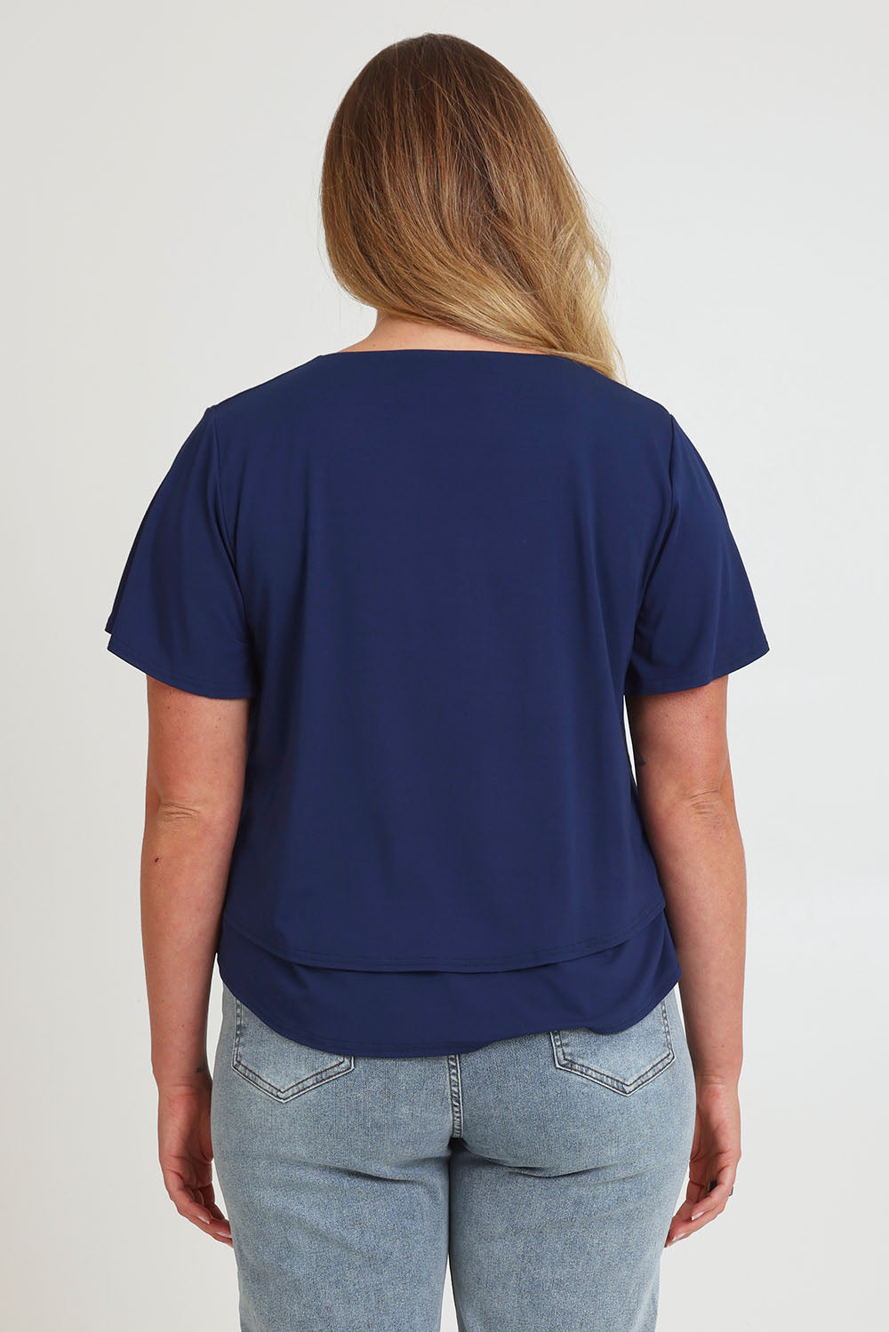Model Chanel wearing size 16 of the Short And Sweet Bamboo Layered Tee in colour Navy (Blue), from the back
