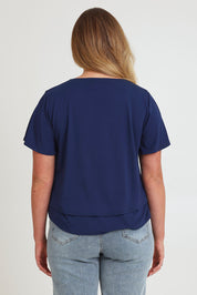 Model Chanel wearing size 16 of the Short And Sweet Bamboo Layered Tee in colour Navy (Blue), from the back
