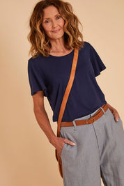 Model Emma wearing size 10 of the Short And Sweet Bamboo Layered Tee in colour Navy (Blue), from the front, showing the whole outfit