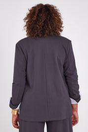 Model Anucia wearing size 14 of the Keeping It Cool Oversized Boyfriend Blazer in colour Castle (Grey), from the back