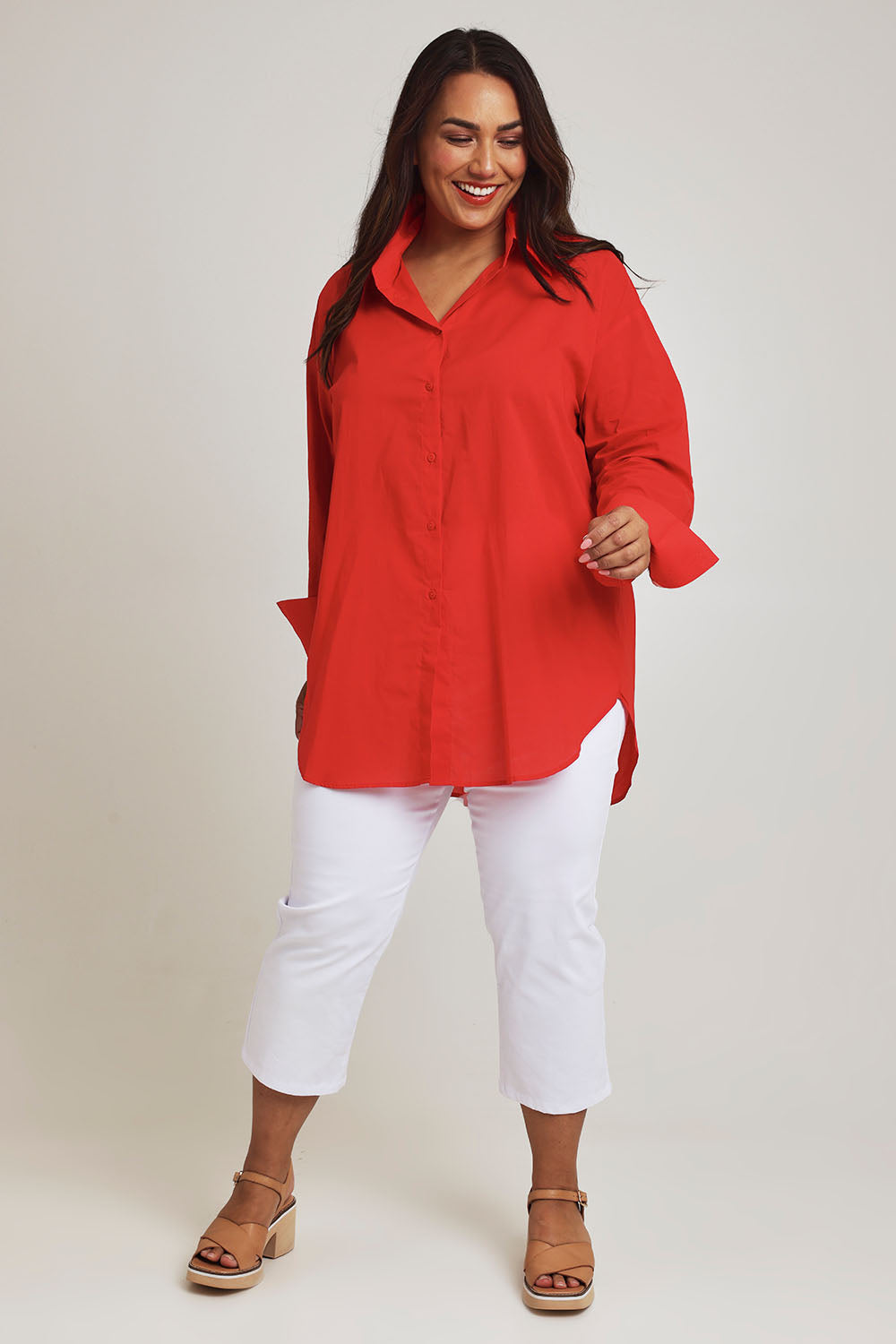 Model Ashleigh wearing size 16 of the Relaxed Elegance Boyfriend Shirt in colour Red (Red), from the front, showing the whole outfit