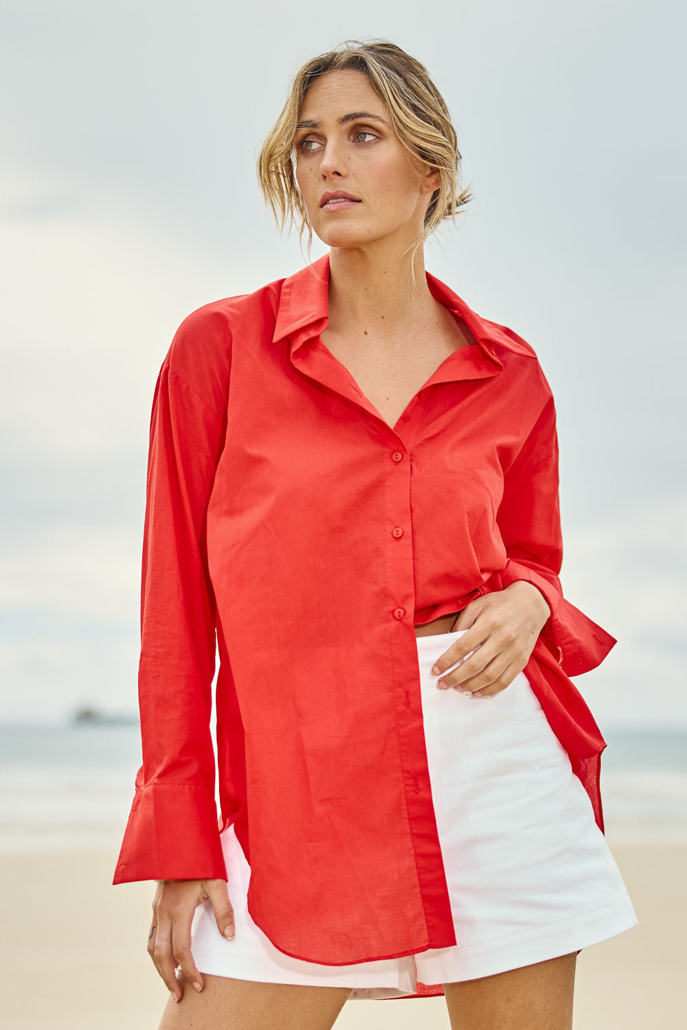 Model Tegan wearing size 10 of the Relaxed Elegance Boyfriend Shirt in colour Red (Red), from the front, showing the whole outfit