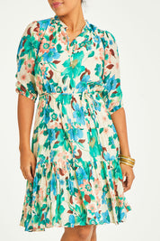 Model Noli wearing size 14 of the Sweet As Sugar Dress in colour Fleurblue (Blue), from the front, cropped image