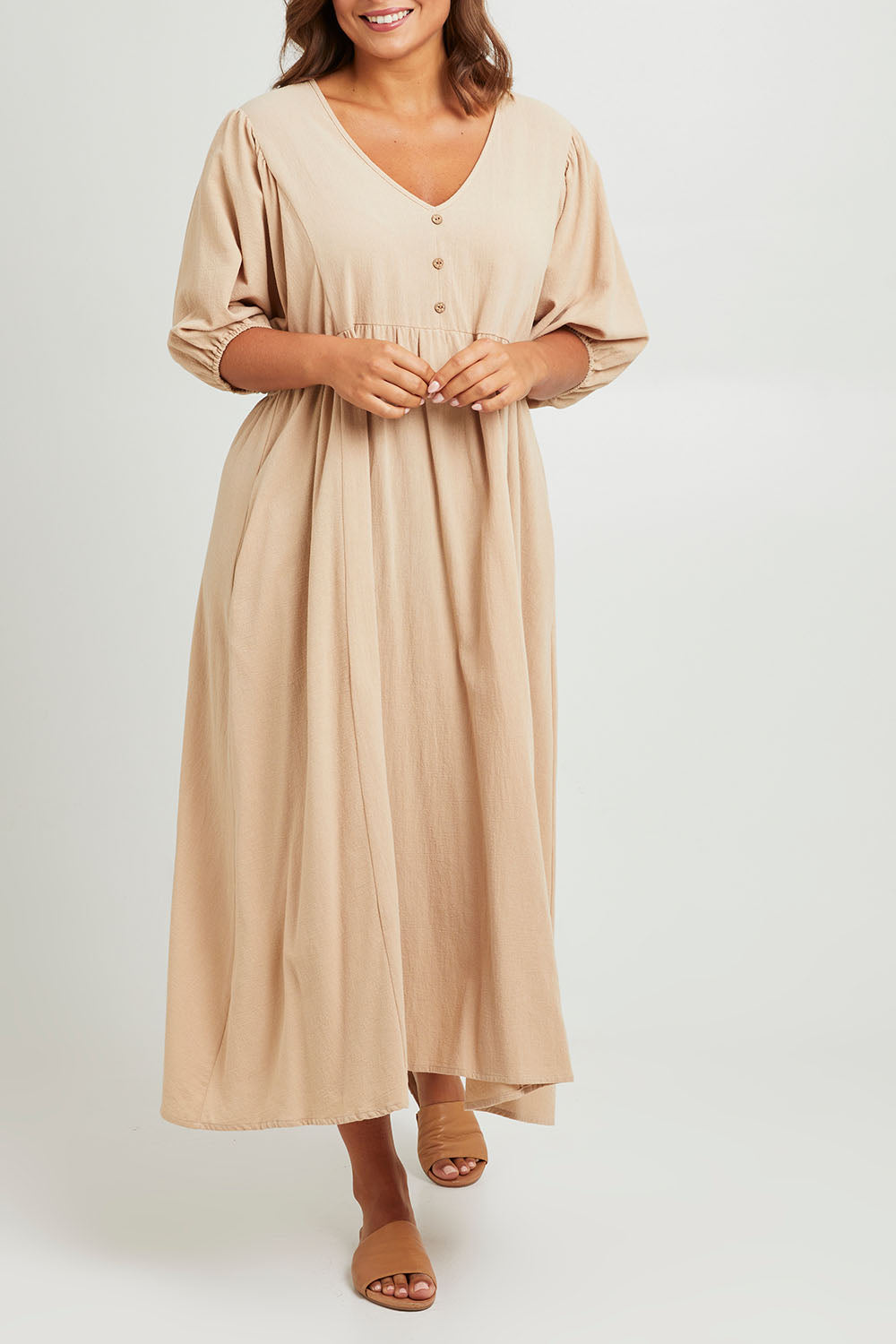 Model Monique wearing size 14 of the Summer Picnic Smock Dress in colour Stone, from the front, cropped image