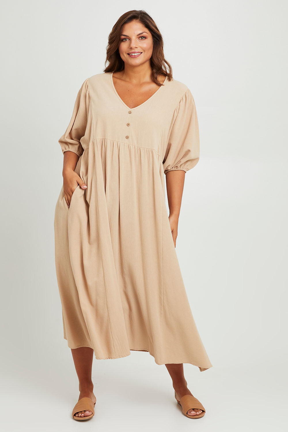 Model Monique wearing size 14 of the Summer Picnic Smock Dress in colour Stone, from the front, showing the whole outfit