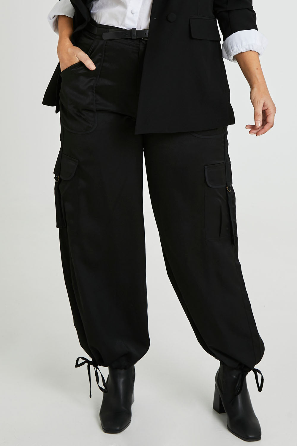 Model Laura wearing size 14 of the Date Night Cargo Pants in colour Black (Black), from the front, cropped image