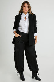 Model Laura wearing size 14 of the Date Night Cargo Pants in colour Black (Black), from the front, showing the whole outfit