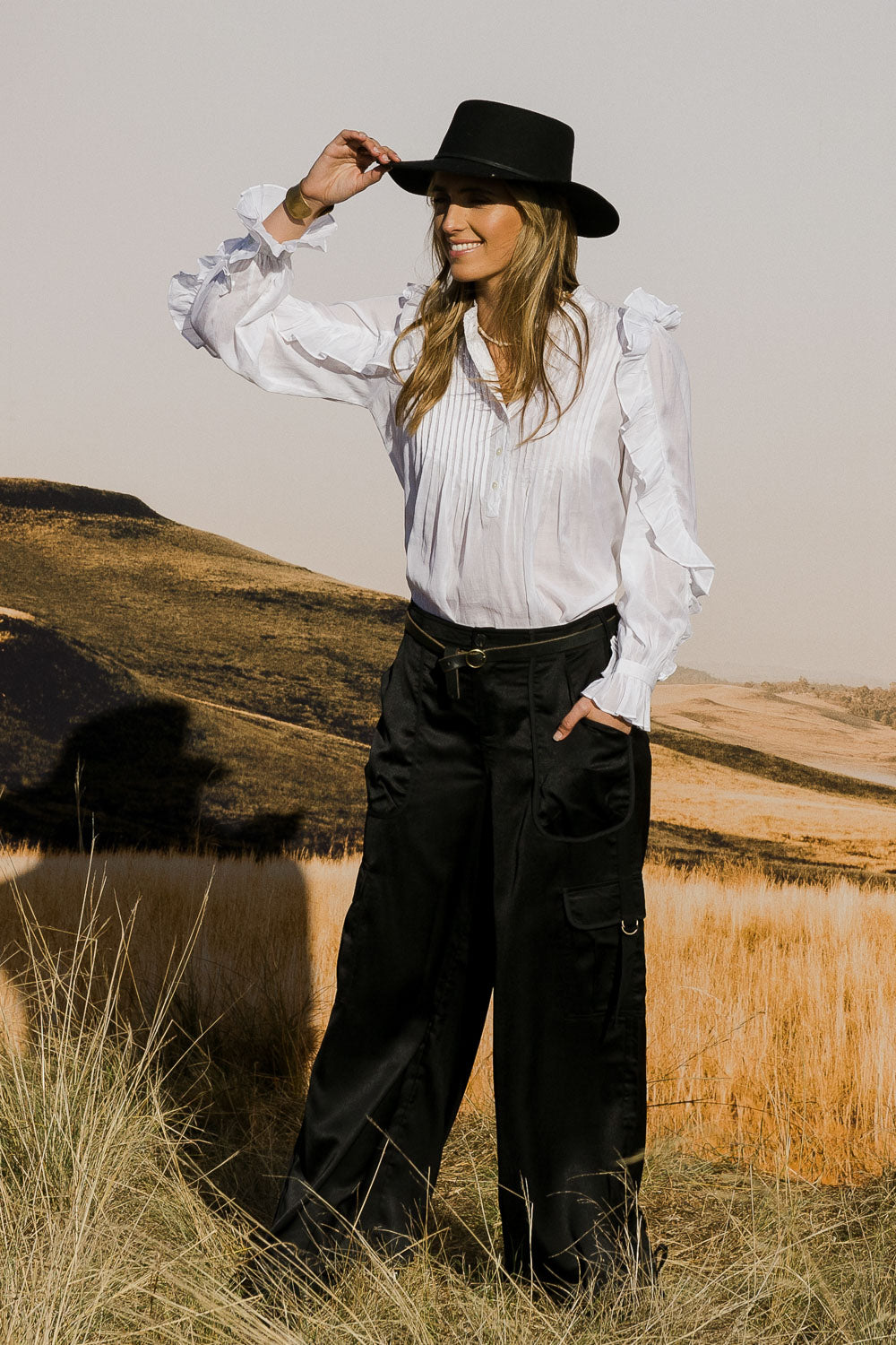 Model Tegan wearing size 10 of the Date Night Cargo Pants in colour Black (Black), from the front, showing the whole outfit