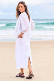 Model Tegan wearing size 10 of the Easy As Pull On Denim Skirt in colour White (White), from the front, showing the whole outfit