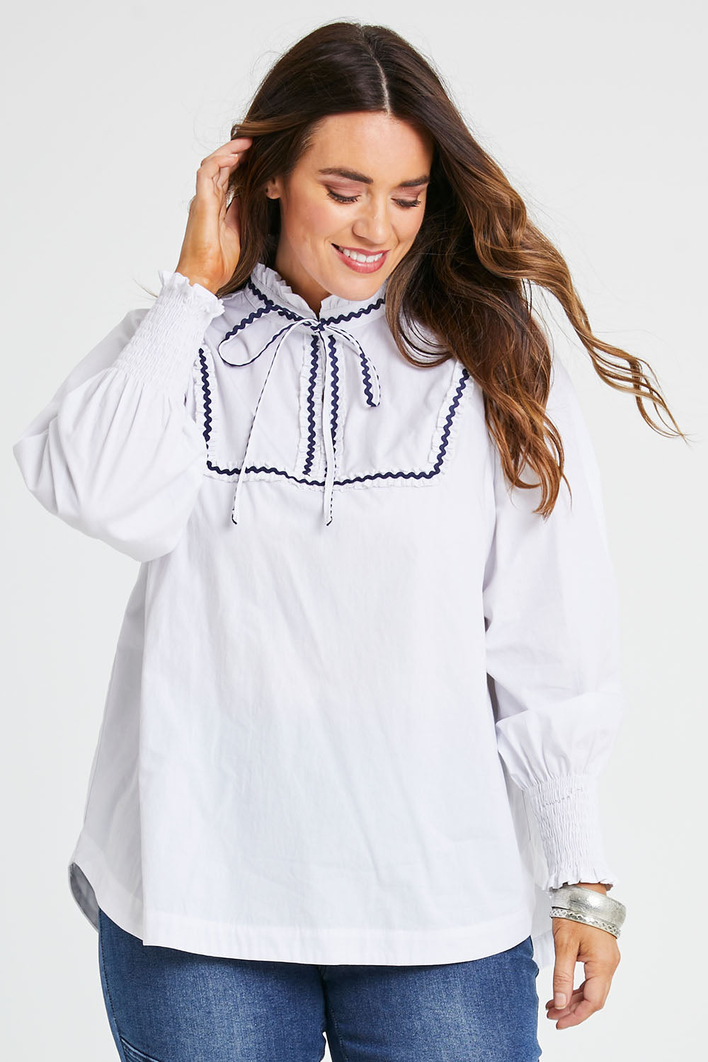 Model Laura wearing size 14 of the Ric Rac Romance Blouse in colour White (White), from the front, cropped image