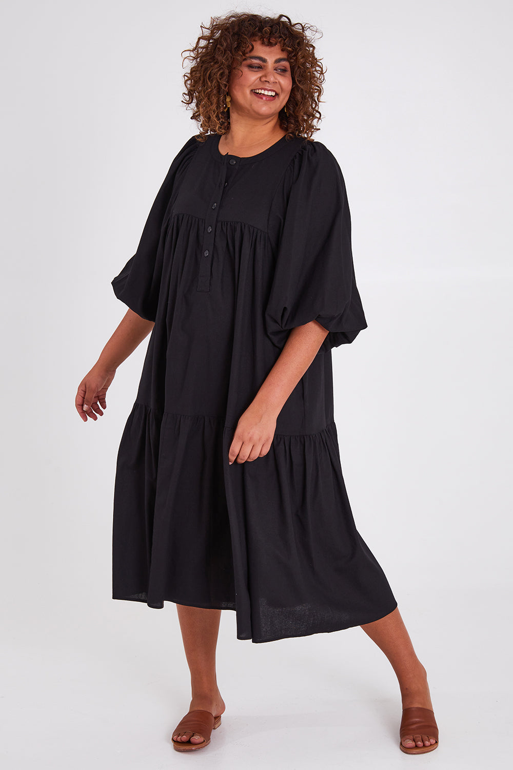 Model Anucia wearing size 14 of the Picture Perfect Linen Dress in colour Black (Black), from the front, showing the whole outfit