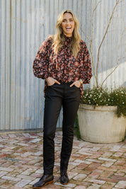 Model Tegan wearing size 10 of the Hot Stuff Coated Jean in colour Black (Black), from the front, showing the whole outfit