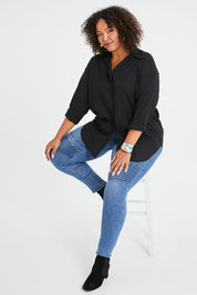 Model Alexis wearing size 16 of the Wild Plains Flat Front Stitch Jeggings in colour Denim (Blue), from the front, showing the whole outfit