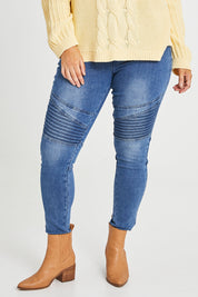 Model Laura wearing size 14 of the Wild Plains Flat Front Stitch Jeggings in colour Denim (Blue), from the front, cropped image