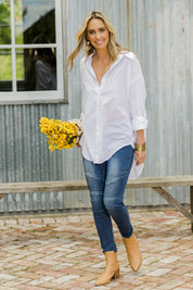 Model Tegan wearing size 10 of the Wild Plains Flat Front Stitch Jeggings in colour Denim (Blue), from the front, showing the whole outfit