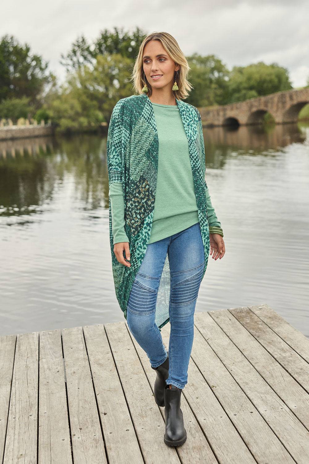 Model Tegan wearing size 10 of the Wild Plains Flat Front Stitch Jeggings in colour Denim (Blue), from the front, showing the whole outfit