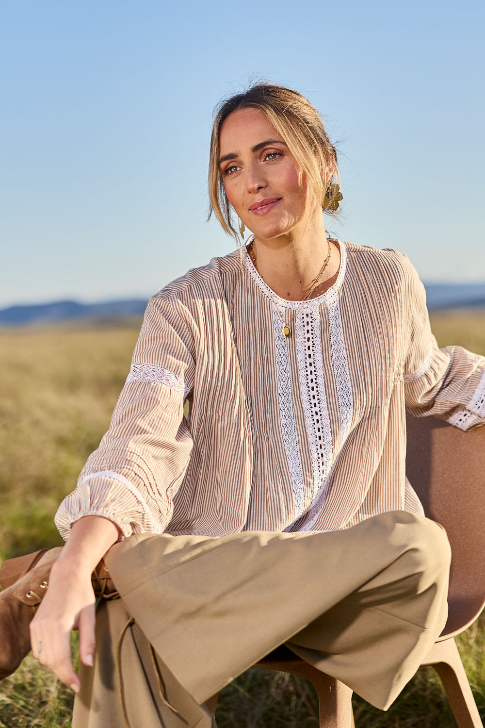 Model Tegan wearing size 10 of the At My Best Button Back Blouse in colour Natstripe, from the front, showing the whole outfit