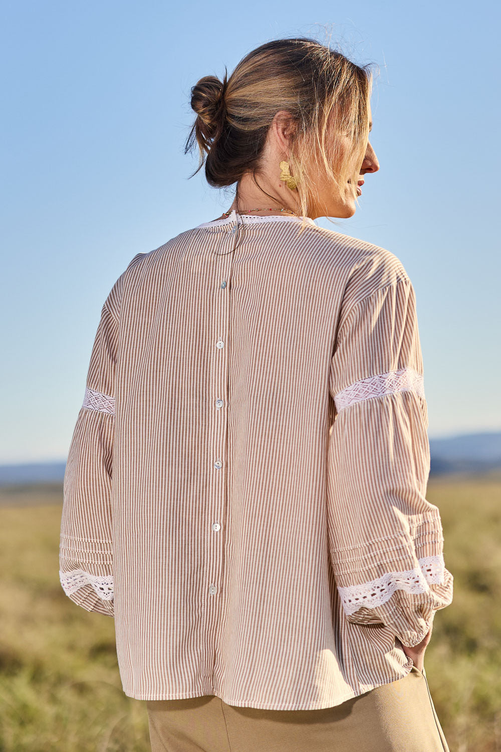 Model Tegan wearing size 10 of the At My Best Button Back Blouse in colour Natstripe, from the front, showing the whole outfit