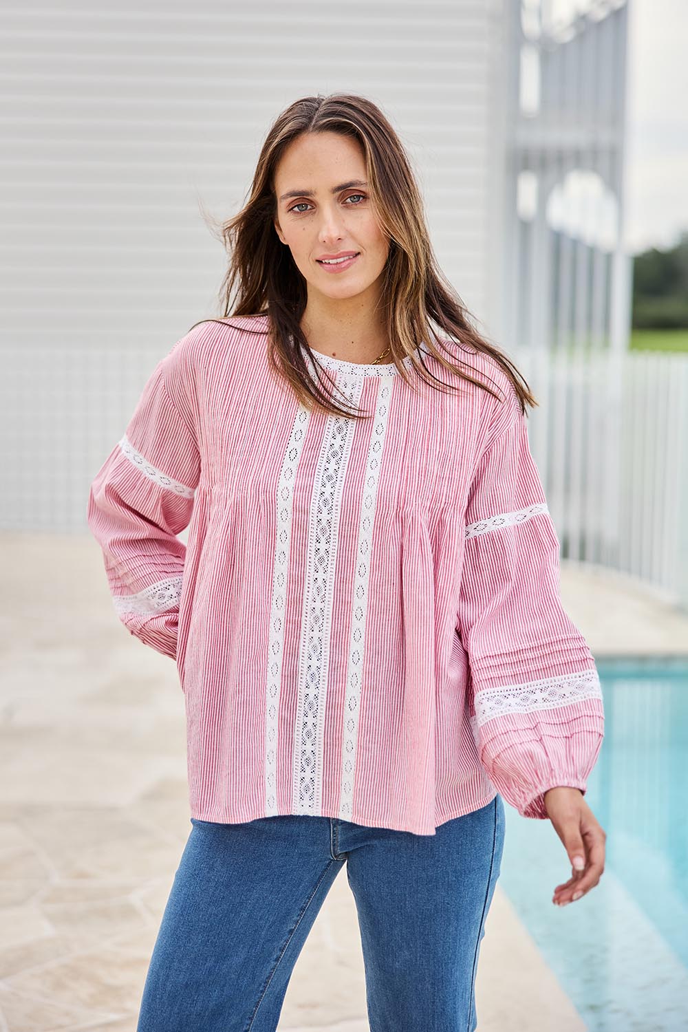 Model Tegand wearing size 10 of the At My Best Button Back Blouse – Redstripe in colour Redstripe, in a cropped view