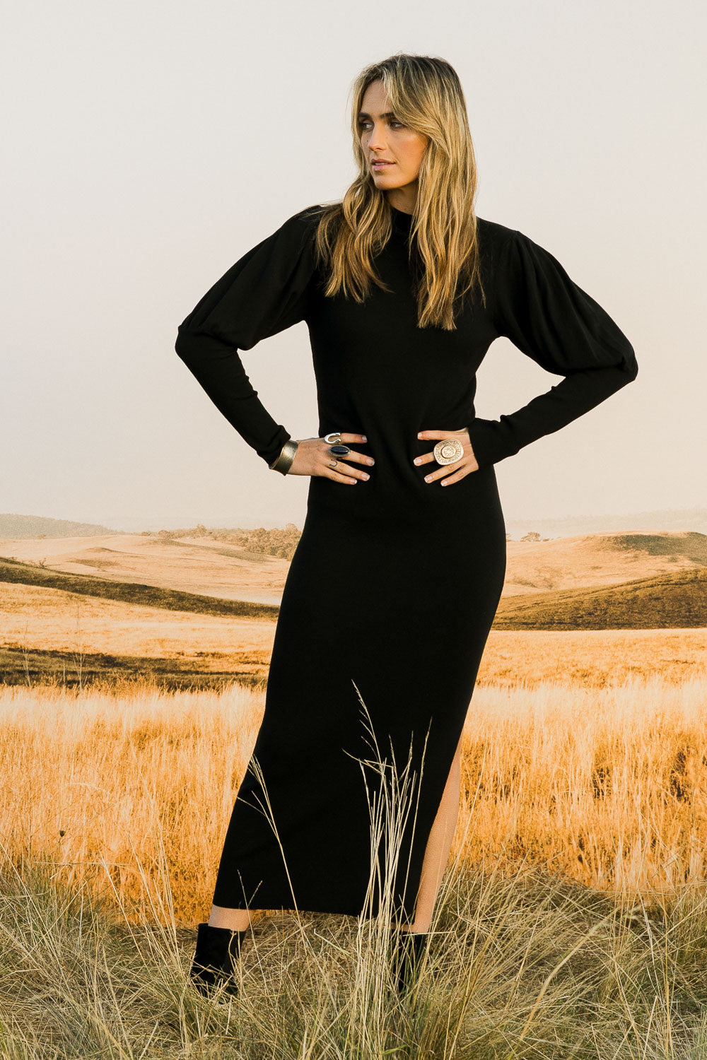 Model Tegan wearing size S of the Day Or Night Balloon Sleeve Dress in colour Black (Black), from the front, showing the whole outfit