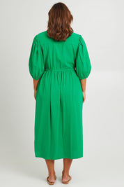 Model Monique wearing size 14 of the For Love And Dancing Dress in colour Emerald (Green), from the back